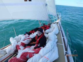 Elaine and Doug relaxing and playing on the kite (pretending to hold it down)