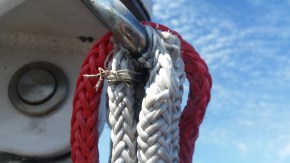 Looks like a repair job soon to happen at top of mast on spinnaker block strop.