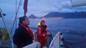 Cape Town in the distance. Dimitri at the helm talking with Matt