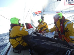 Flaking the sail so it can be put down below in sail locker