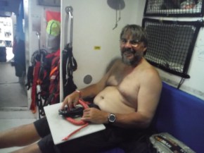 Craig (Mr. Montana) doing his magic on putting his doughnut on the spinnaker block to be repaired. 