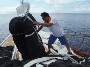 Han directing putting Yankee sail into sail locker.