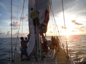 Another shot of bringing the main down at sunset one evening.